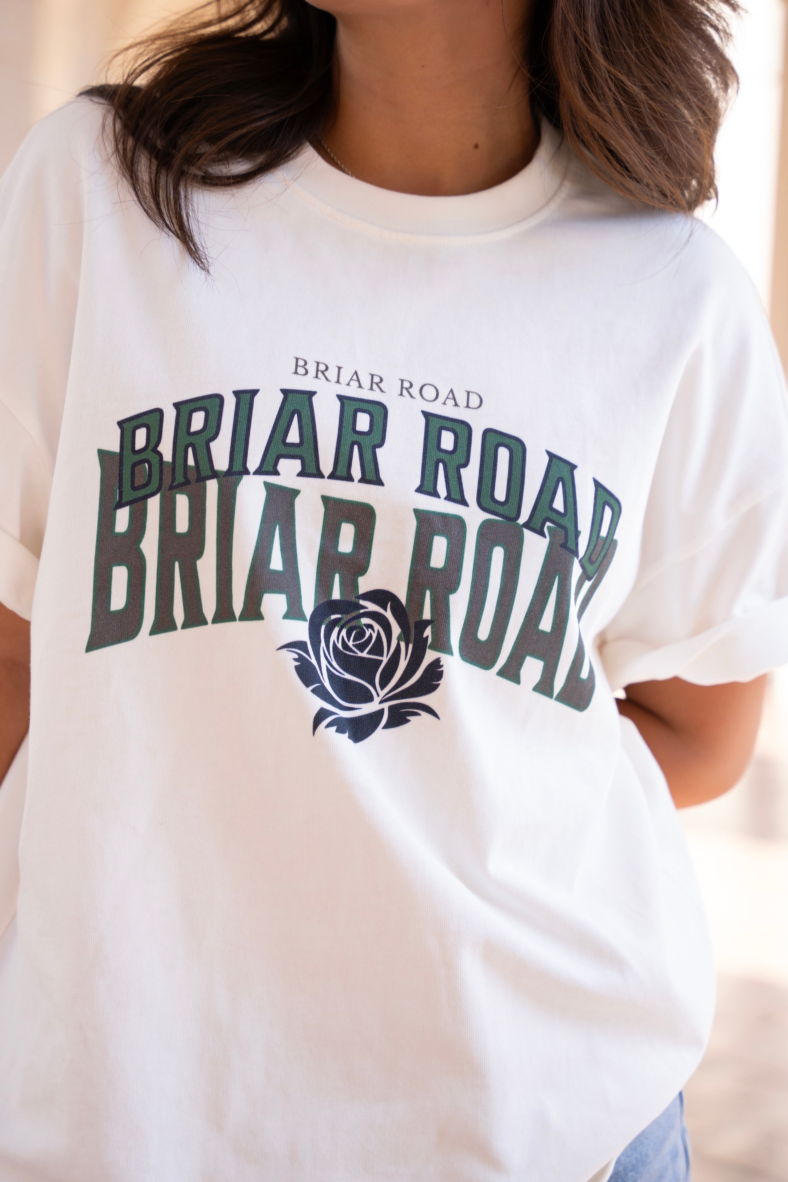 Close up of white oversized woman's crewneck with Briar Road branding