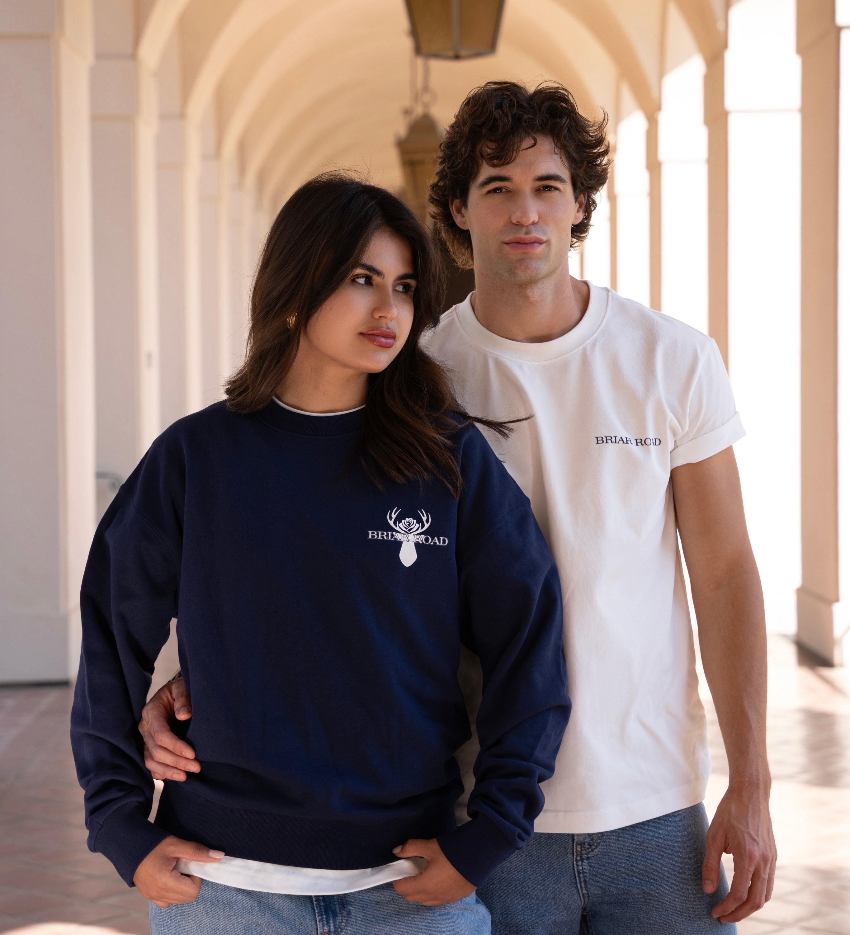 Woman wearing navy blue long sleeved crewneck and man wearing white crewneck tshirt