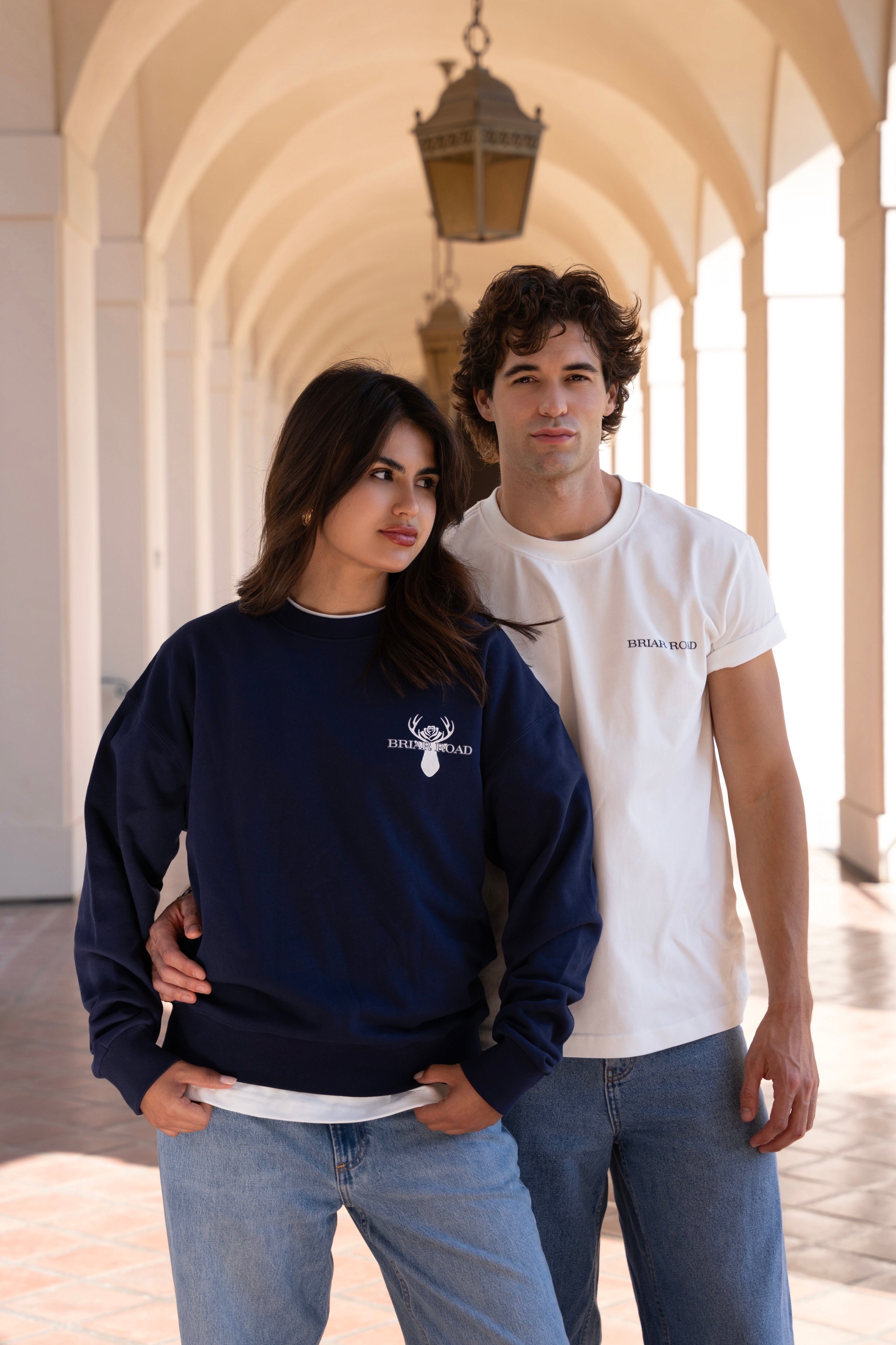 Woman wearing navy blue long sleeved crewneck and man wearing white crewneck tshirt