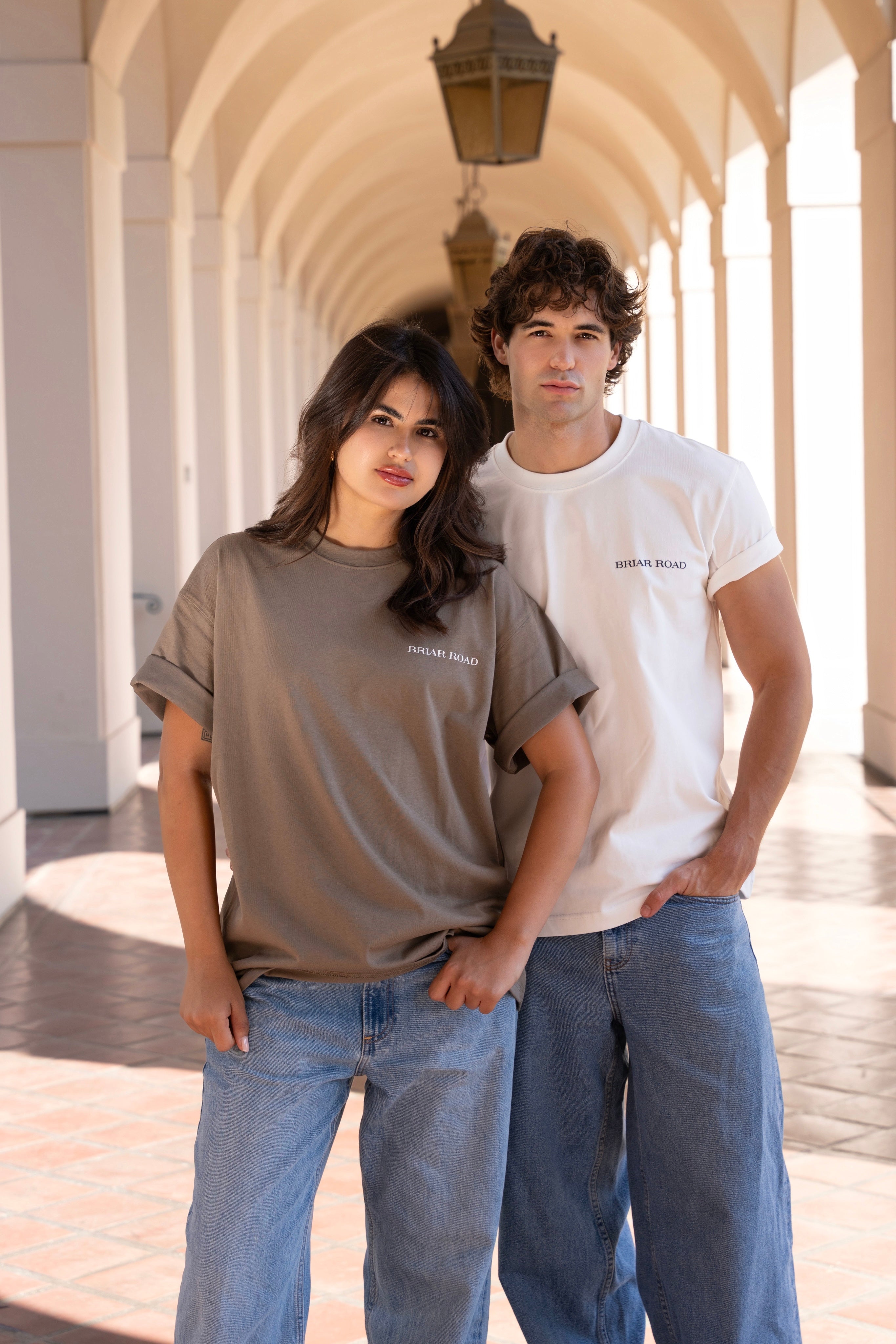 Man wearing varsity crewneck and woman wearing oversized crewneck
