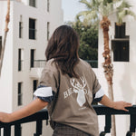 Woman wearing cotton crewneck featuring Briar Road logo and shorts 