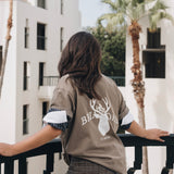 Woman wearing cotton crewneck featuring Briar Road logo and shorts 