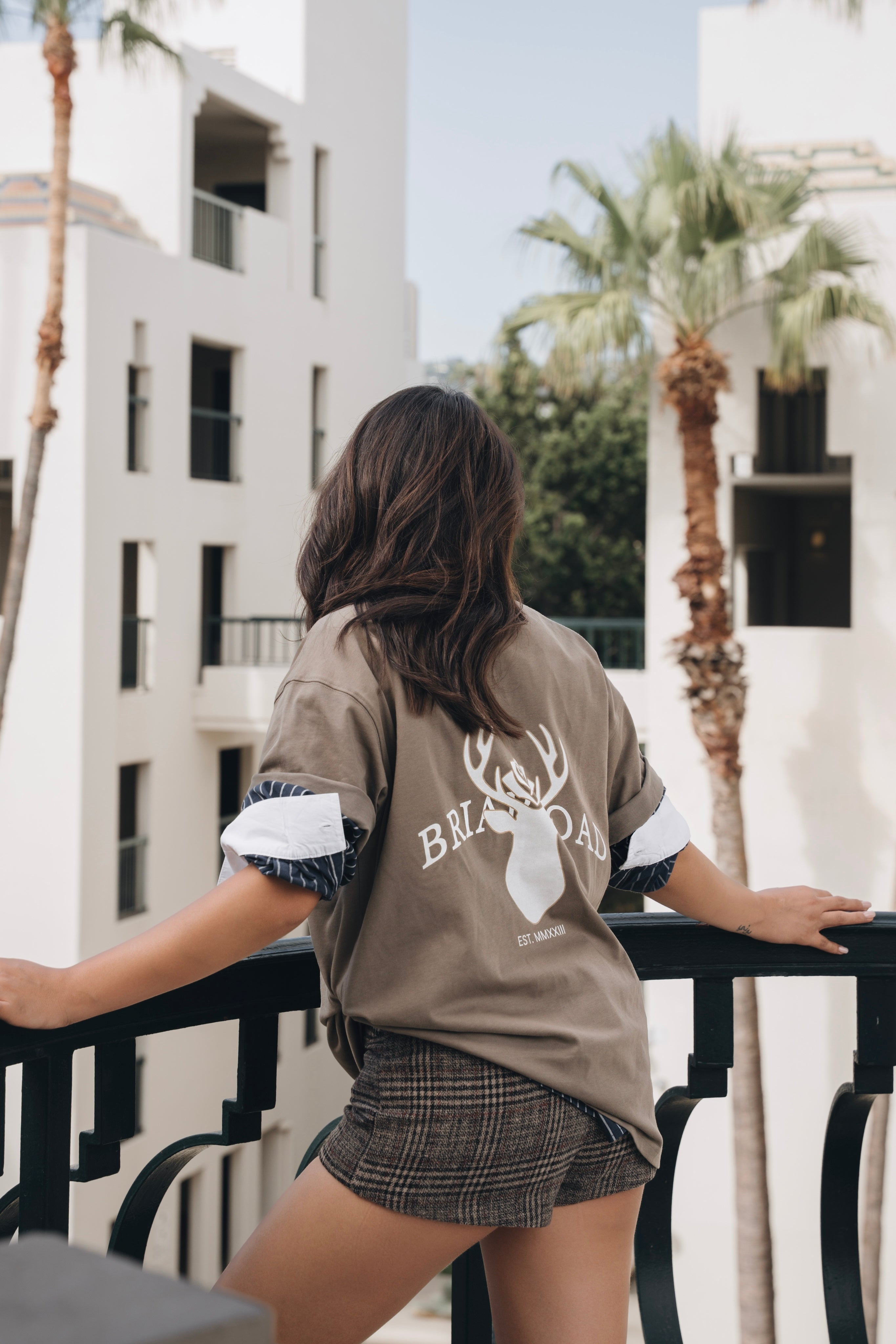 Woman wearing cotton crewneck featuring Briar Road logo and shorts 