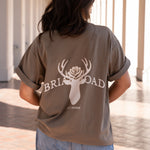 Woman wearing brown oversized crewneck sweatshirt featuring Briar Road logo